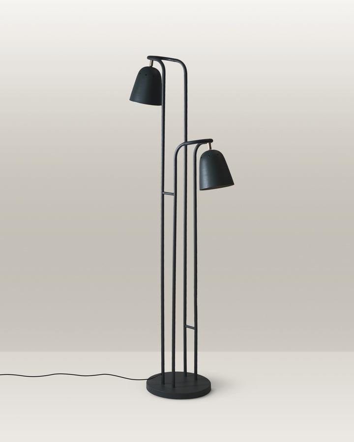 Floor lamp with a sleek design, dual-head configuration, and matte green finish.